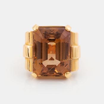 An 18K gold ring set with a step-cut citrine.