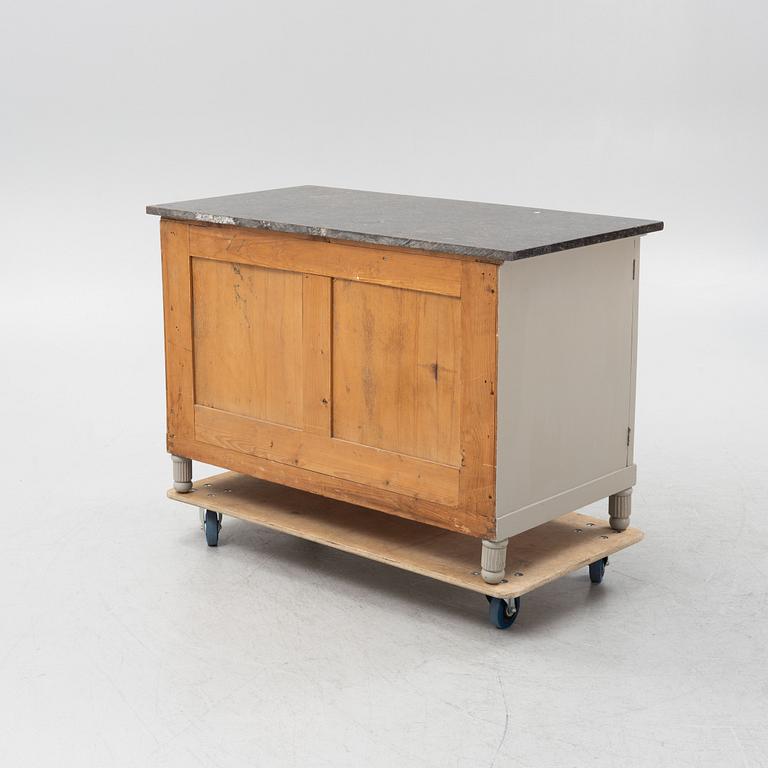 A painted dresser with a stone top, from around the year 1900.