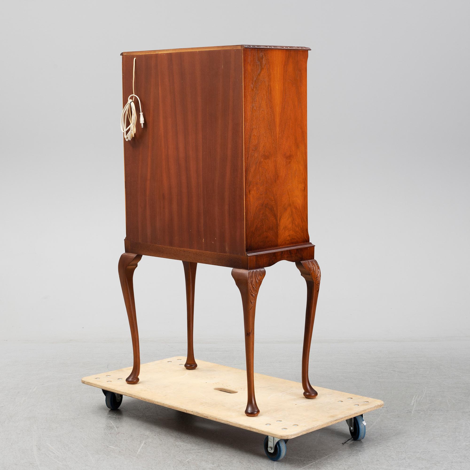 A mid 20th century walnut veneered bar cabinet.