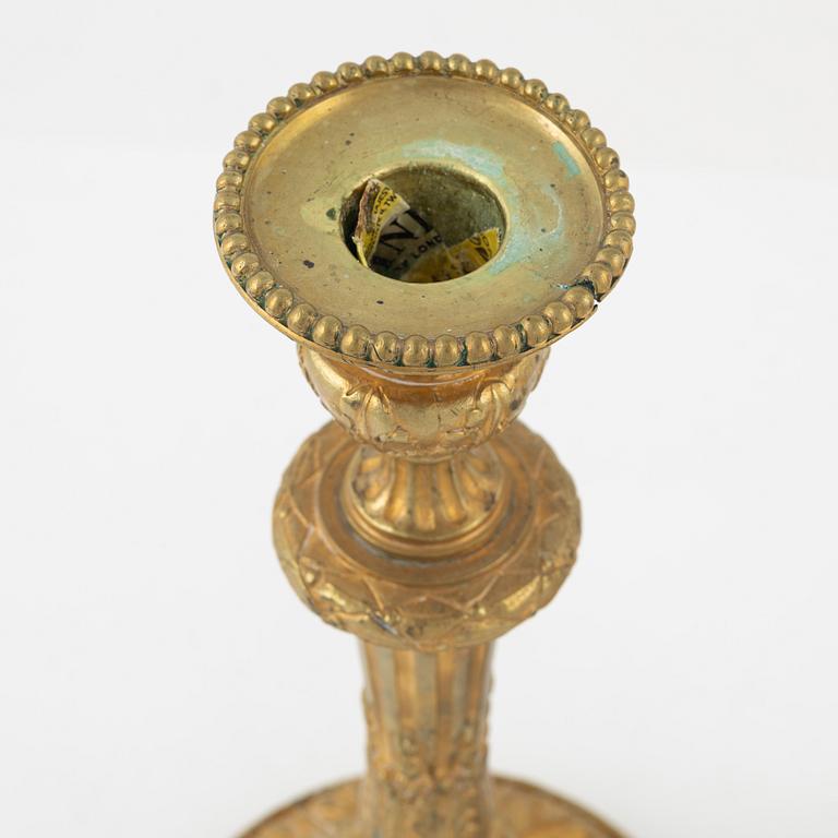 A pair of bronze candle sticks, 20th Century.