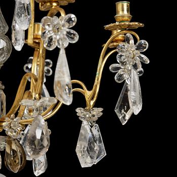 A near pair of Franch Louis-XV-style nine-branch gilt bronze and rock crystal chandeliers, later part 19th century.