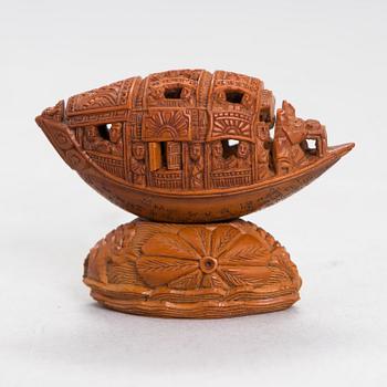 A Chinese nut boat sculpture, with poem.