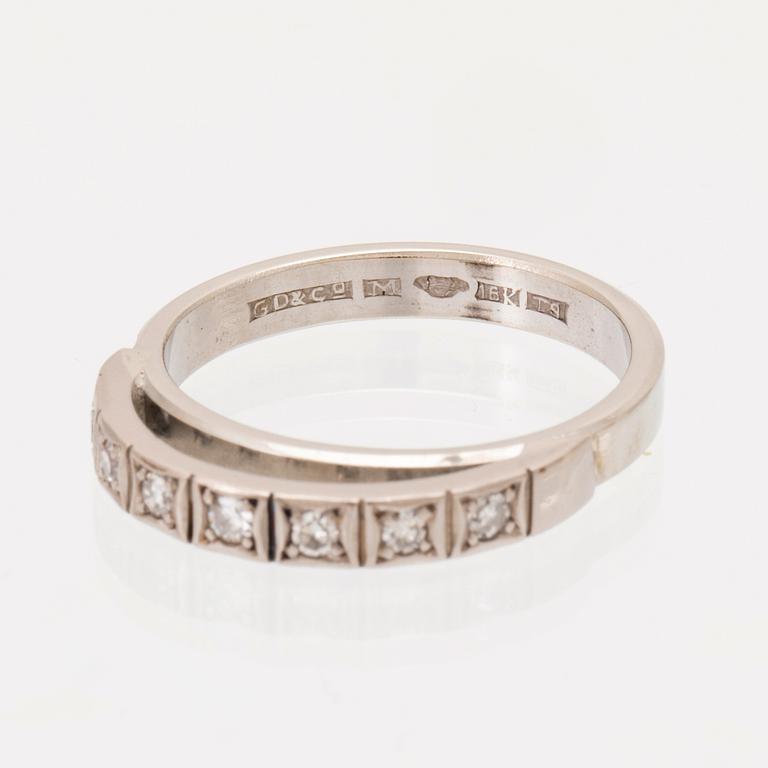 An 18K white gold ring set with round single cut dimamonds.