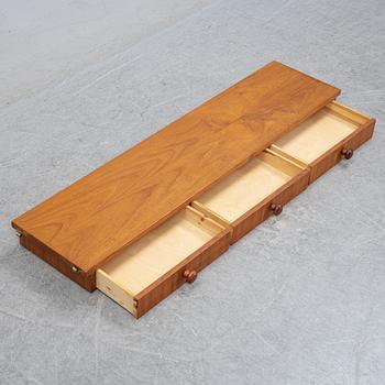 Nils Strinning, A 1950's-60's teak veneered shelf with brackets.