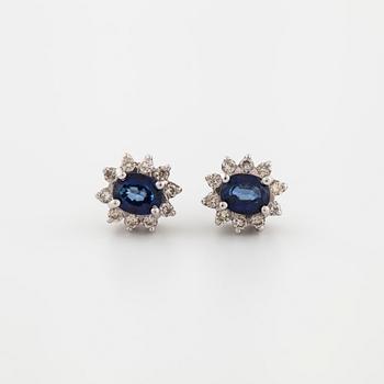 A pair of brilliant cut diamond and sapphire earrings.