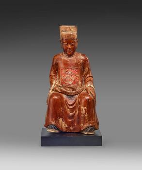 A seated, gilded and lacquered wooden scultpure of a mandarin official, Qing dynasty, 19th Century.