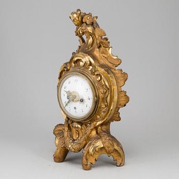 A swedish rococo gilt wood mantle clock.