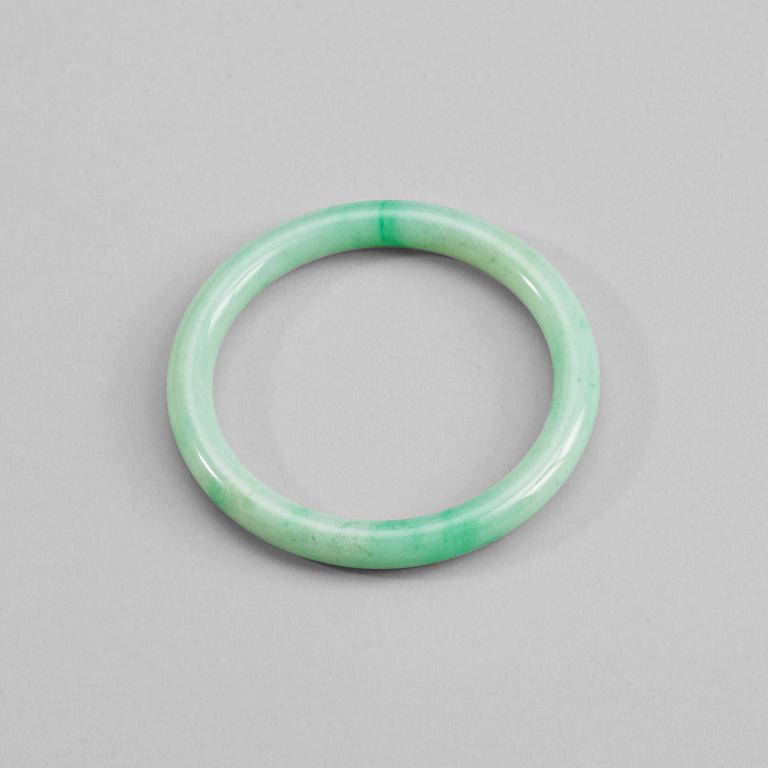 A green jadeite bangle, China, 20th Century.