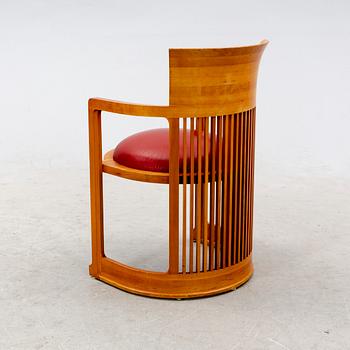 A cherry wood model 606 'Barrel' chair by Frank Lloyd Wright from Cassina.