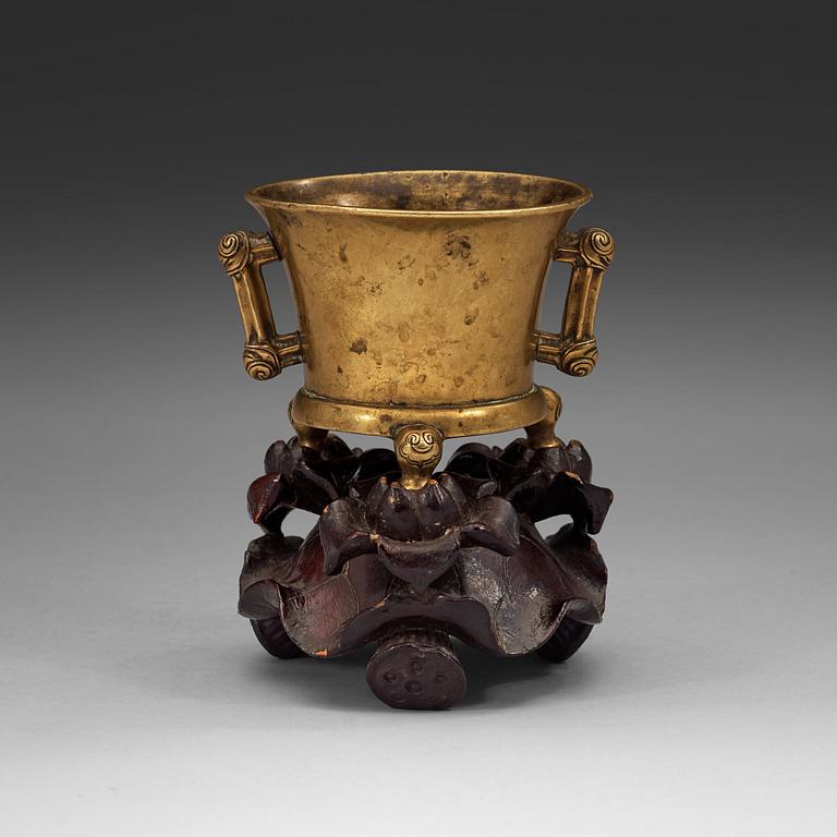 A gilt copper alloy tripod censer, Qing dynasty, presumably 18th Century with Xuandes six character mark.