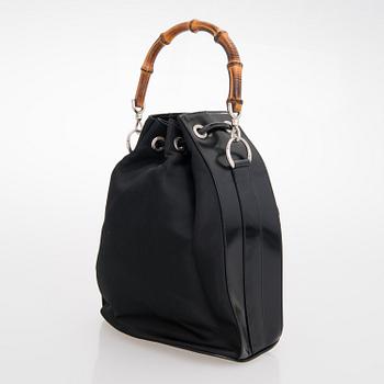 GUCCI, a black nylon handbag.
