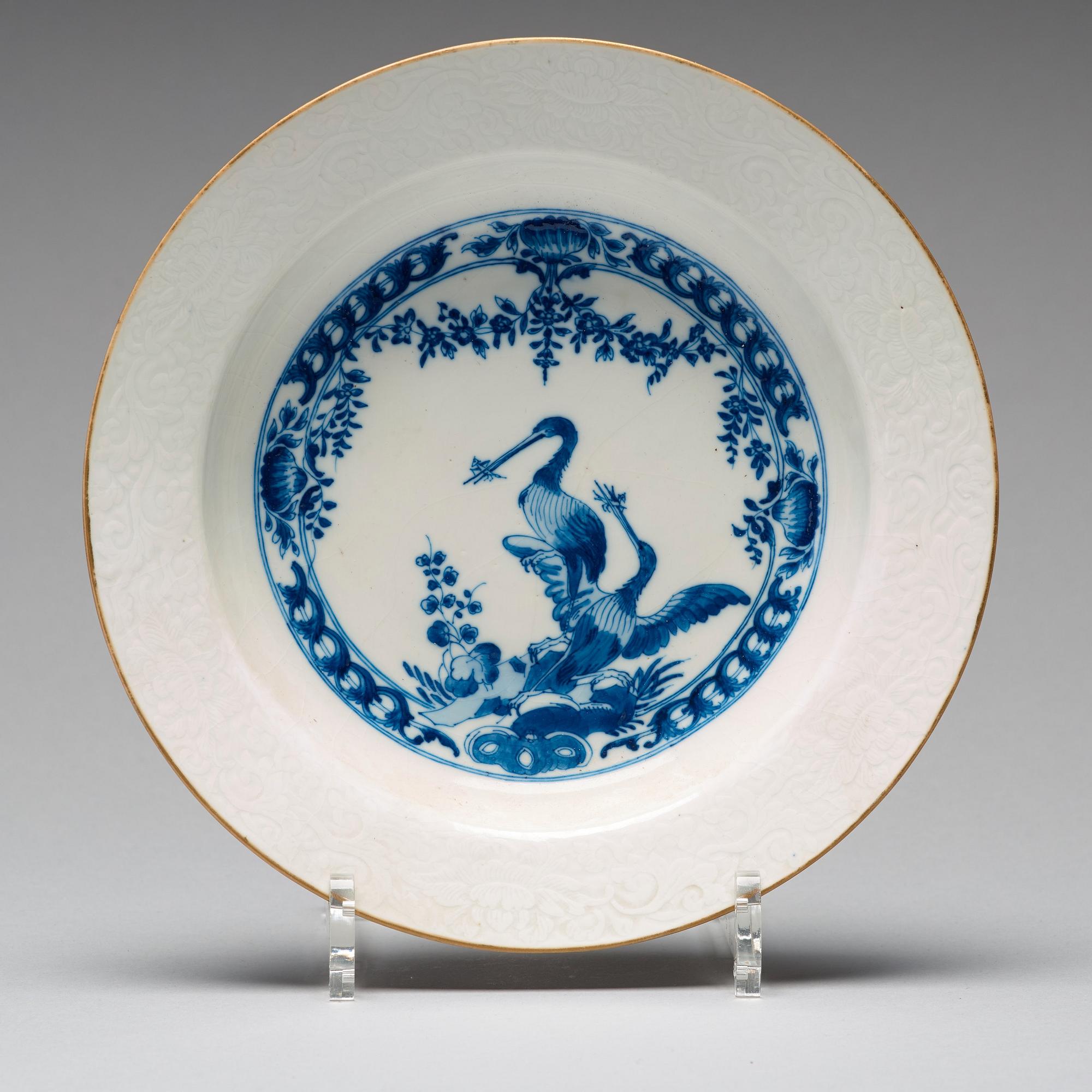 A set of eight blue and white armorial soup dishes, Qing dynasty, 18th Century.