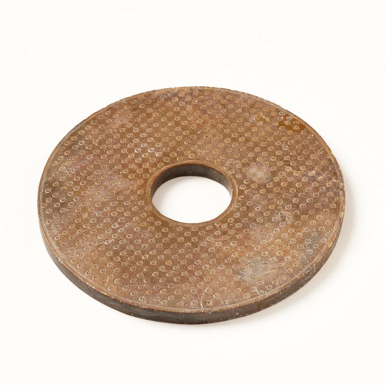 A stone bi disc, Han dynasty (206 B.C.-220 A.D.).