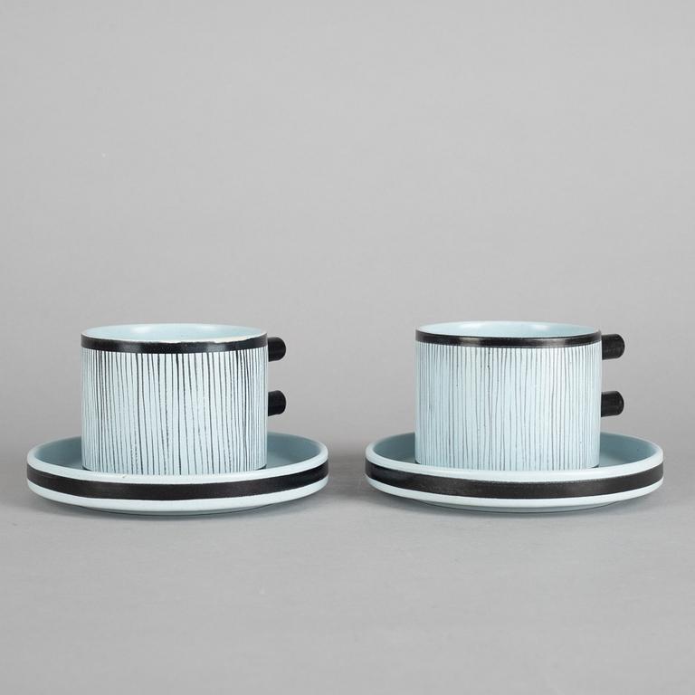 Stig Lindberg, a pair of faience tea cups with saucers, model 200, Gustavsberg studio.