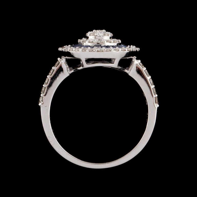 RING, 18k vitguld med 63 briljantslipade diamanter, tot  0.67 ct, samt 24 blå safirer, tot 0.72 ct. Vikt 5 g.