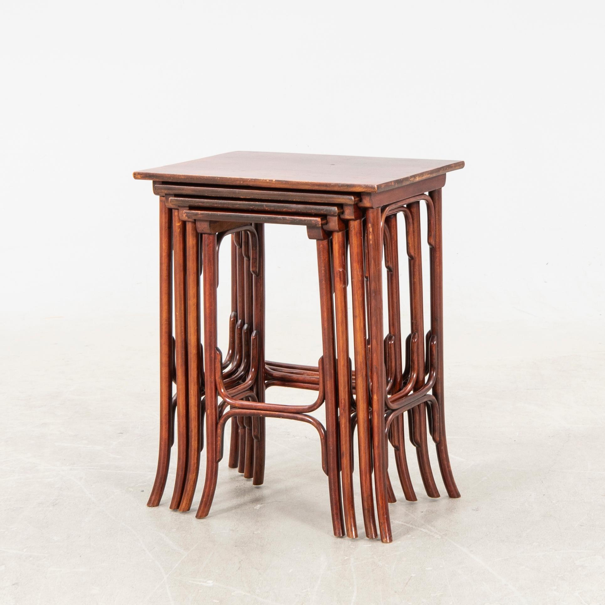 An early 19th century nest of four tables in stained beech from Thonet.