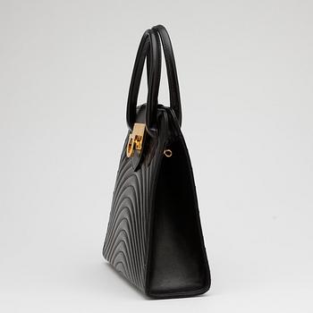 JEAN MICHEL NOUVEAU, a black leather top handle purse.