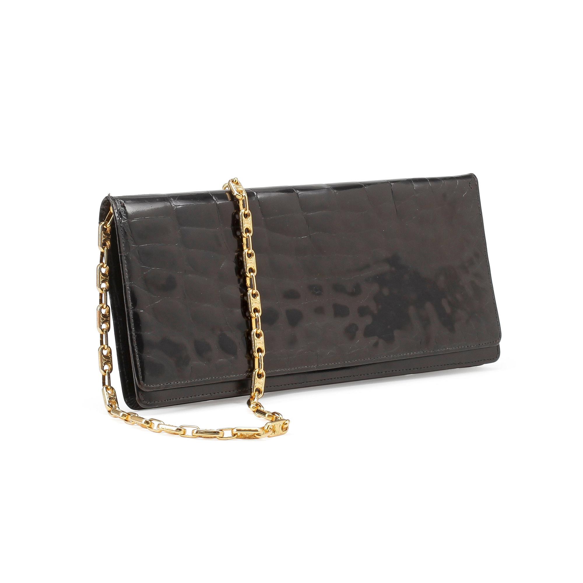 CÈLINE, a black croco clutch.