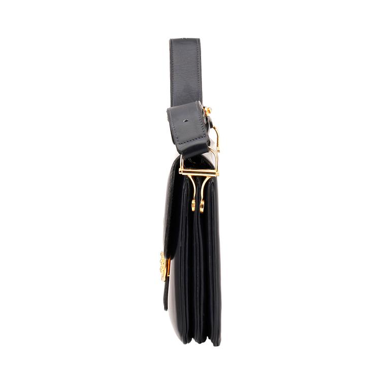 CÉLINE, a dark blue leather shoulder bag.