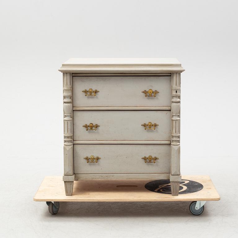 A painted chest of drawers from around the year 1900.