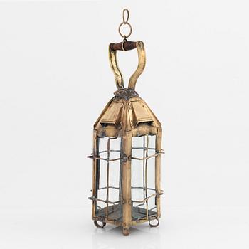 A metal storm lantern, marked A.T, circa 1900.