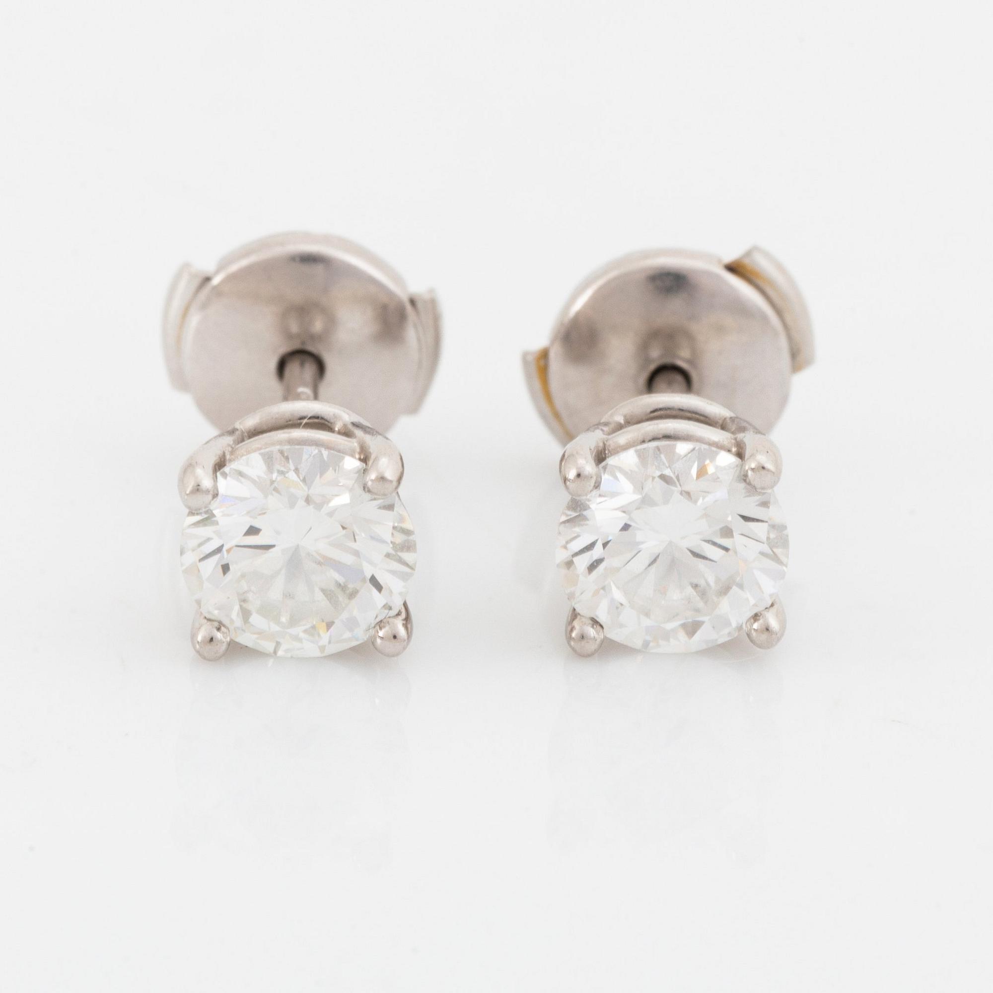 A pair of Tiffany solitaire diamond stud earrings in platinum.