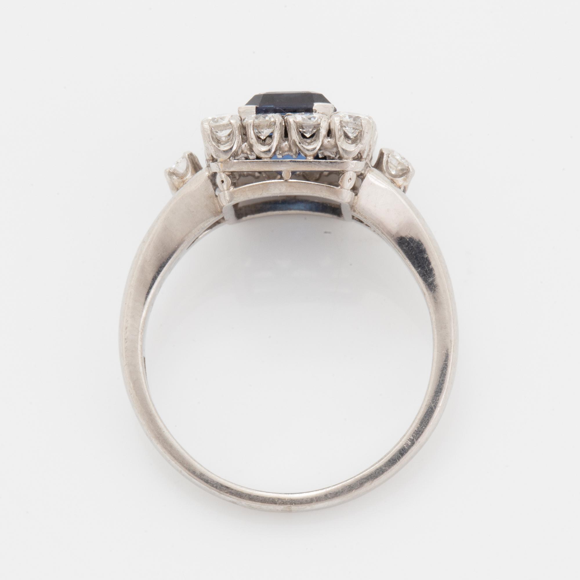 A platinum ring set with a faceted sapphire.