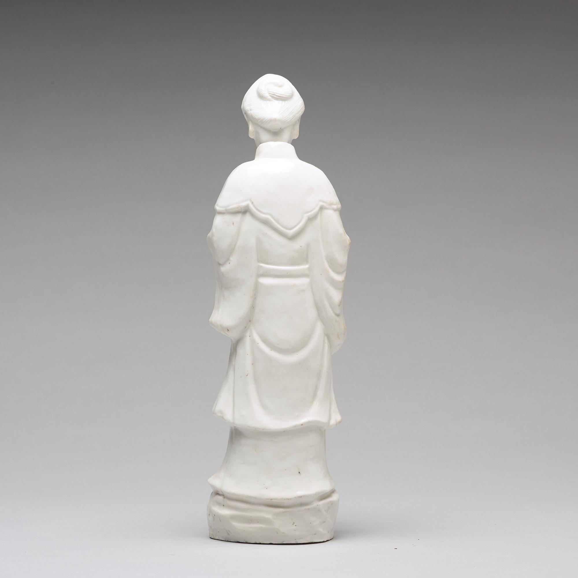 A blanc de chine figure of a lady-in-waiting, Qing dynasty, Kangxi (1662-1722).