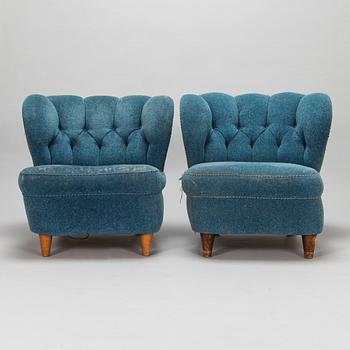 A pair of mid-20th-century armchairs.