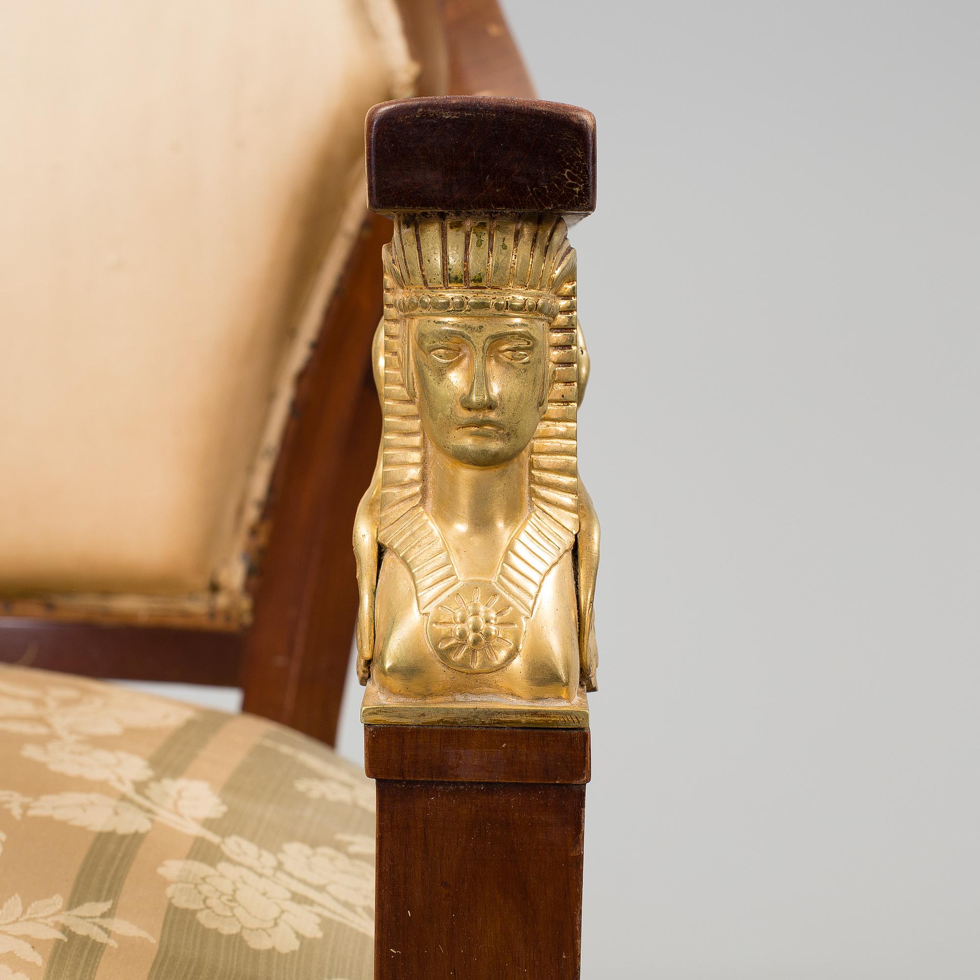 A pair of early 20th century Empire style armchairs.