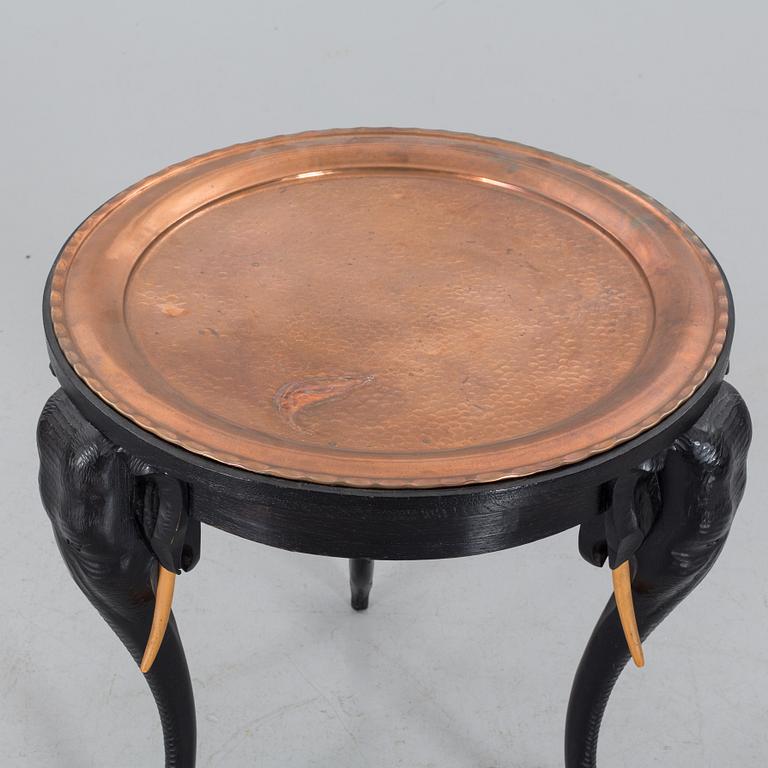 An early 20th Century smoking table, wood and copper.