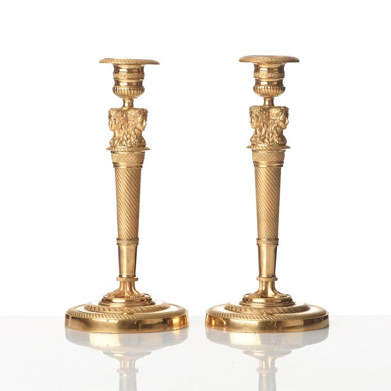 A pair of French Empire early 19th century gilt bronze candlesticks.