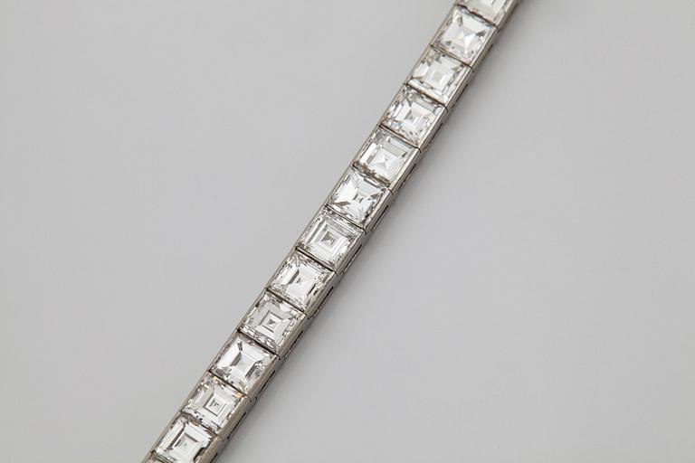 A platinum bracelet set with carré cut diamonds.