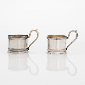 K. Fabergé, a pair of parcel-gilt silver teaglass holders, Imperial Warrant mark, Moscow 1908-17.