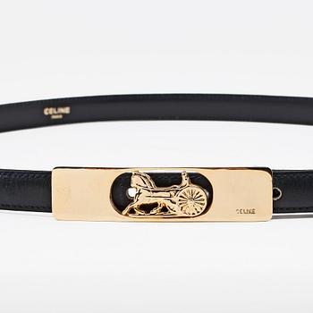 CÉLINE, a dark blue leather belt.