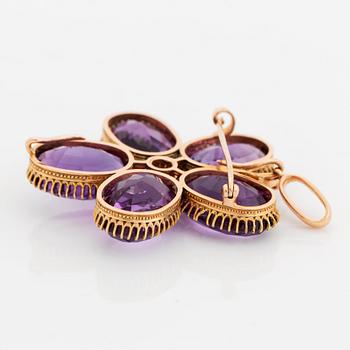 An 18K gold brooch/pendant set with faceted amethysts and a pearl.