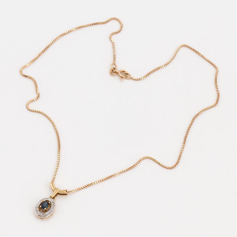 An 18K gold chain and pendant set with an oval, mixed-cut, synthetic sapphire surrounded by eight-cut diamonds.