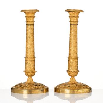 A pair of French Empire ormolu candlesticks, Paris, early 19th century.
