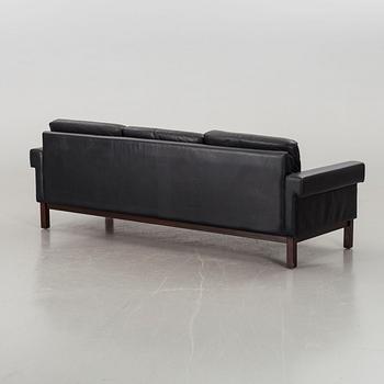 A BLACK LEATHER SOFA.