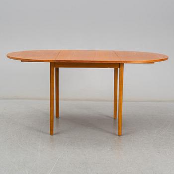 A second half of the 20th century teak veneered dining table.