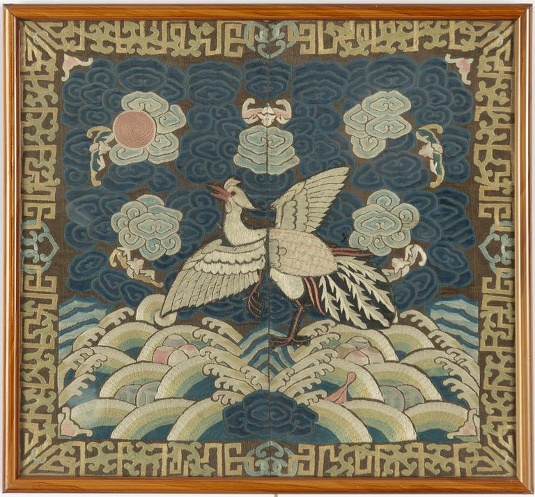 An embroidered civil official's rank badge with a bird, 'buzi', Qing dynasty.