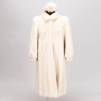 A Long White Mink Coat with a Hat by Osman Ali Finland.