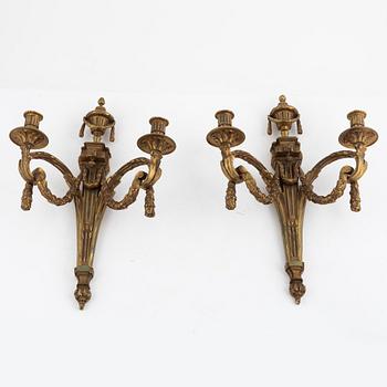 A pair of Louis XVI-style bronze wall sconces, late 19th century.