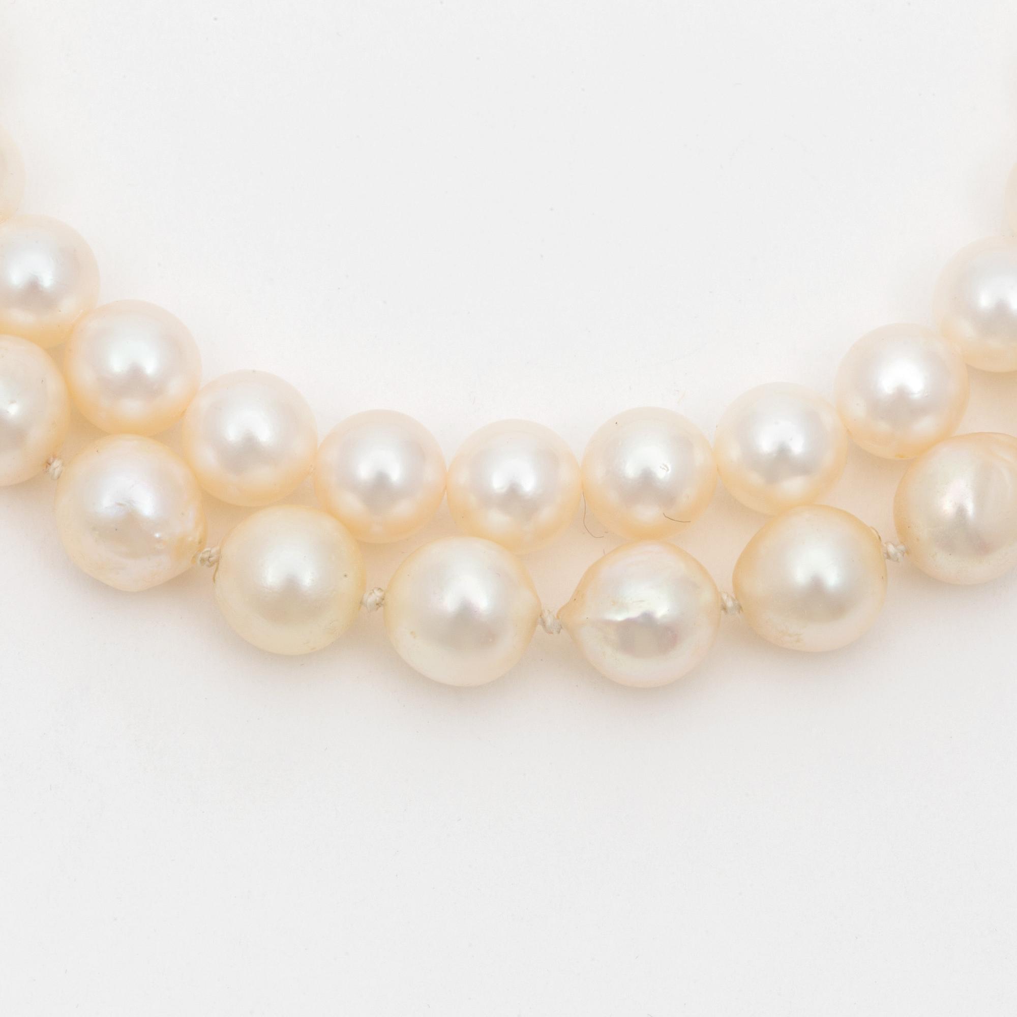 Two cultured pearl necklaces with silver clasps.