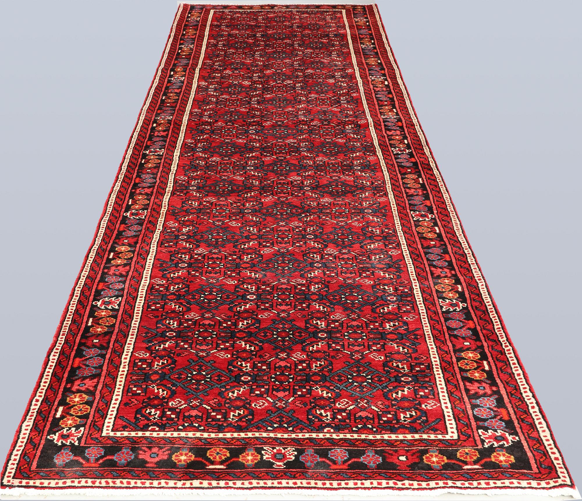 A Hosseinabad runner, c. 418 x 118 cm.