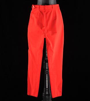 A pair of orange trousers by Hermès.