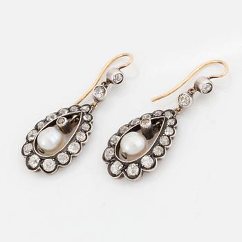 A pair of silver and gold earrings set with old-cut diamonds and pearls.