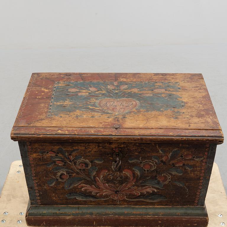 A painted pine chest from Bjuråker, Hälsingland, dated 1828.