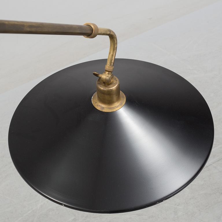 A 20th century brass and painted metal swing-arm wall light.