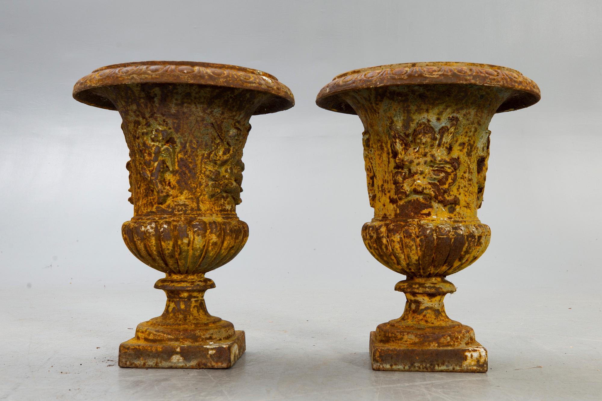 A pair of cast iron garden urns fist half of the 20th century.